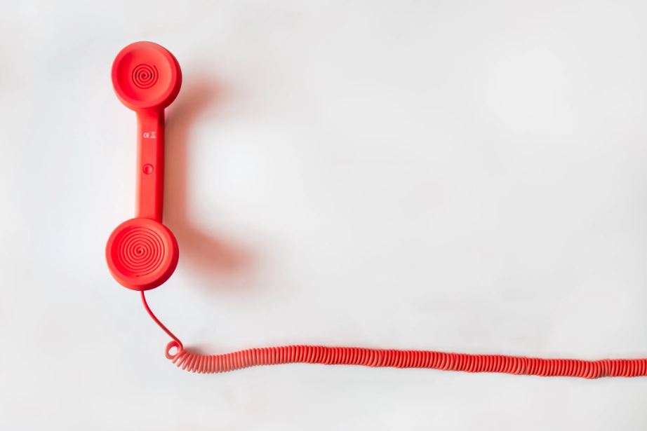 A red phone against a white background