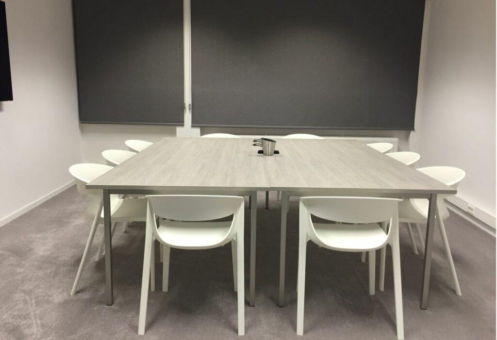 Chairs around a large table in an office
