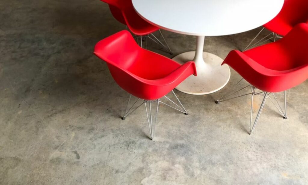 Red chairs around a white table
