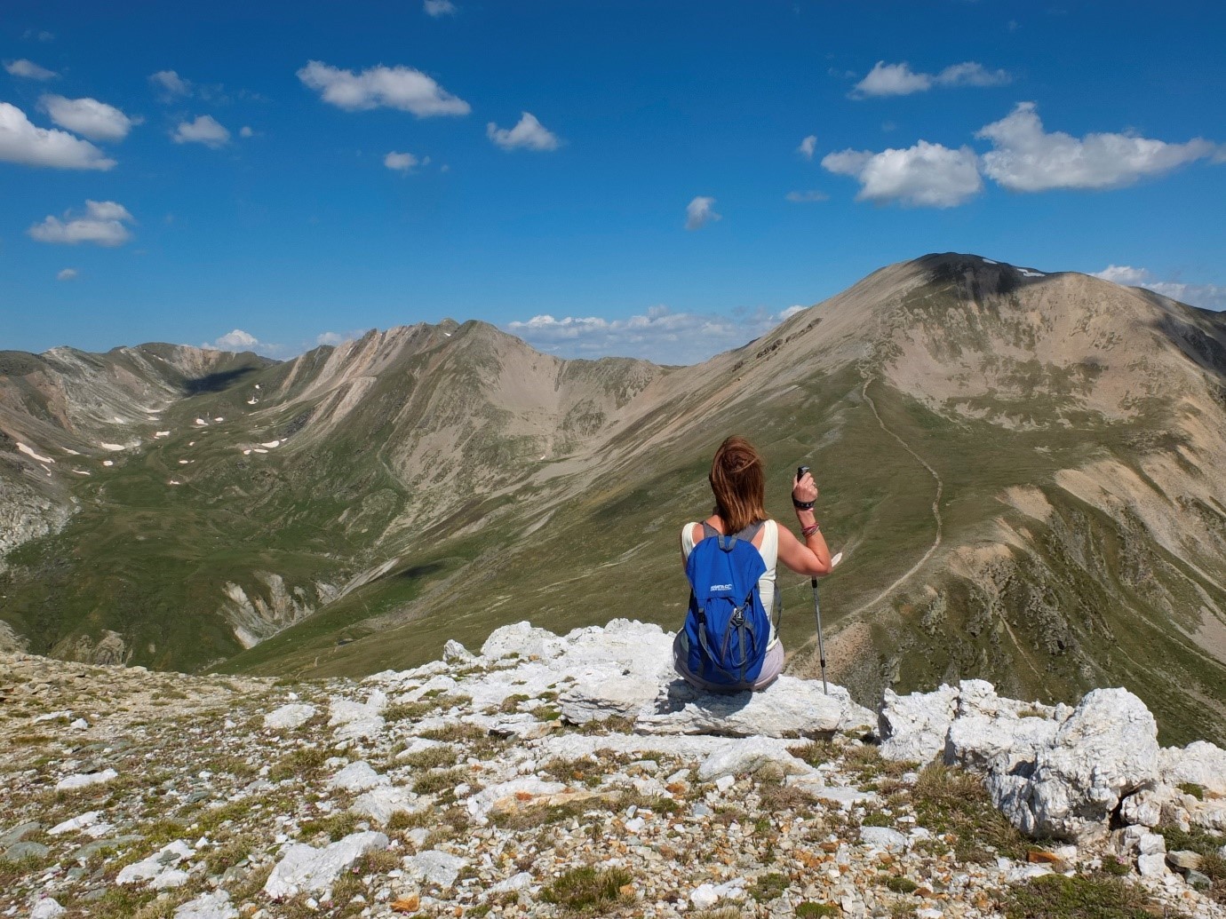 A person sitting at the top of a mountain