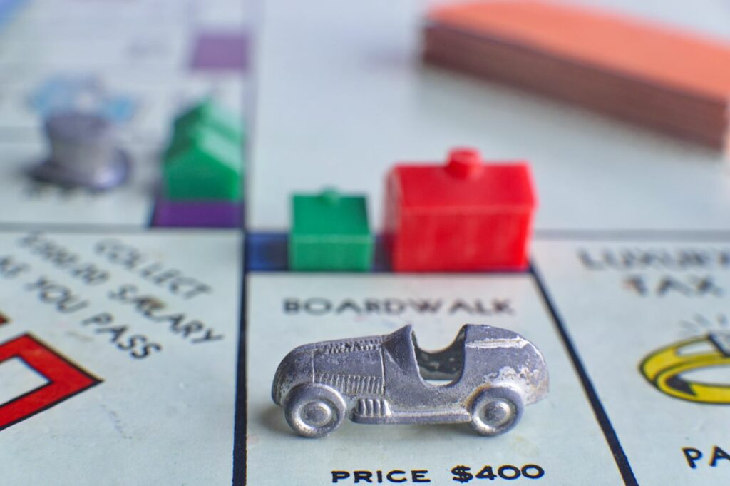 A small metal car on a Monopoly board