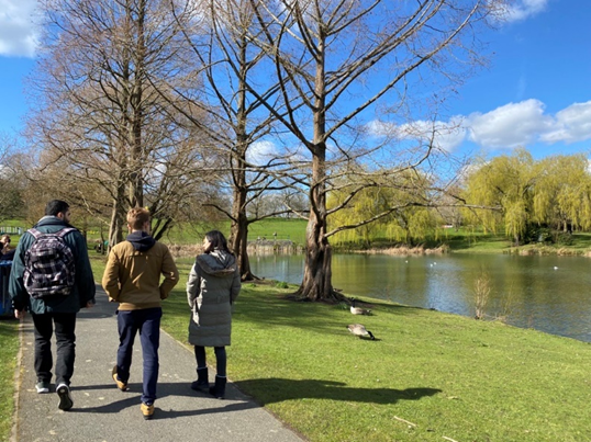 People walking by a river