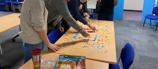 People doing a jigsaw