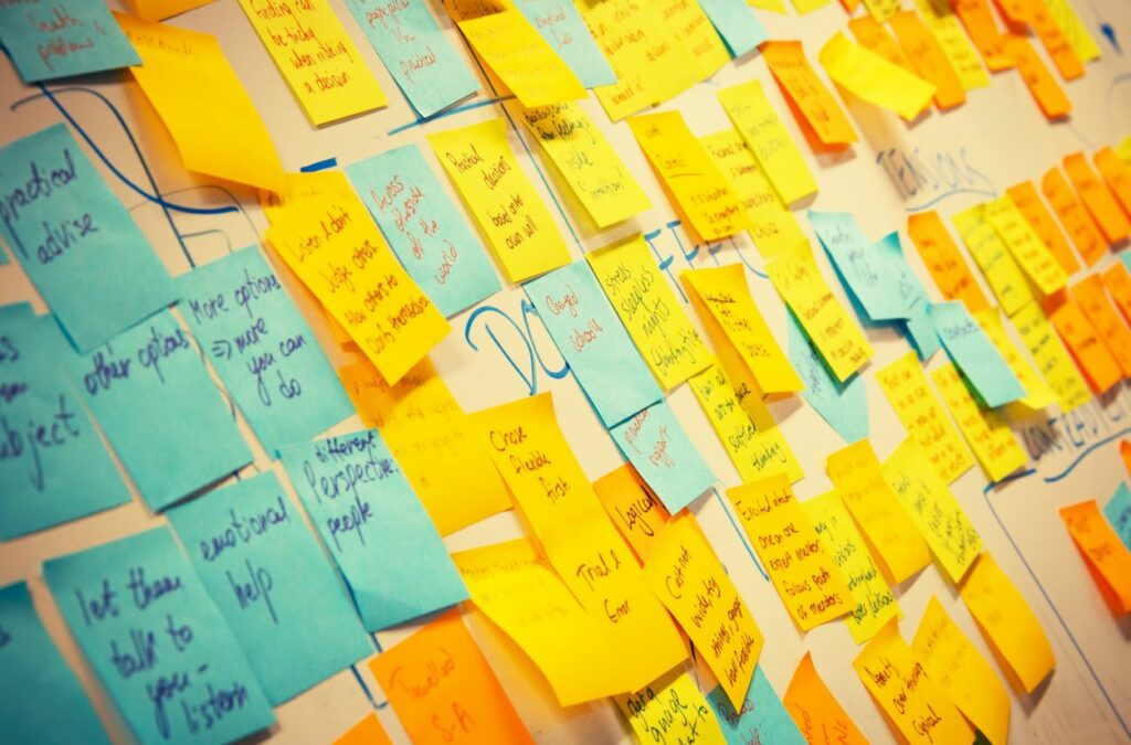 Blue and yellow post it notes on a board