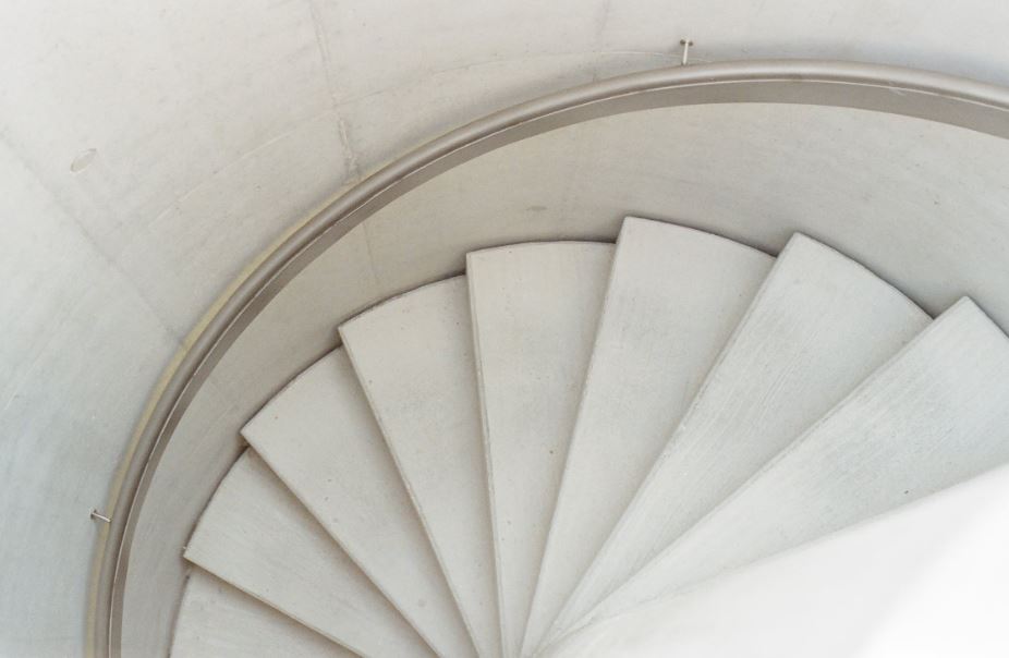 A white, stone spiral staircase